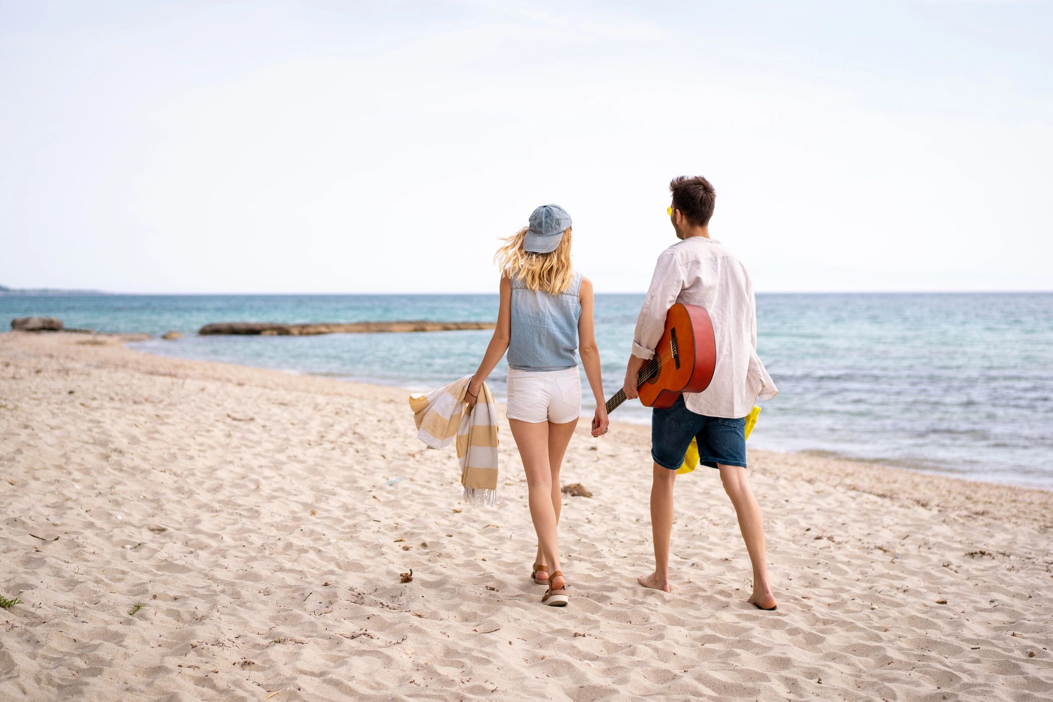 Couple walking on a beach for a destination wedding getaway