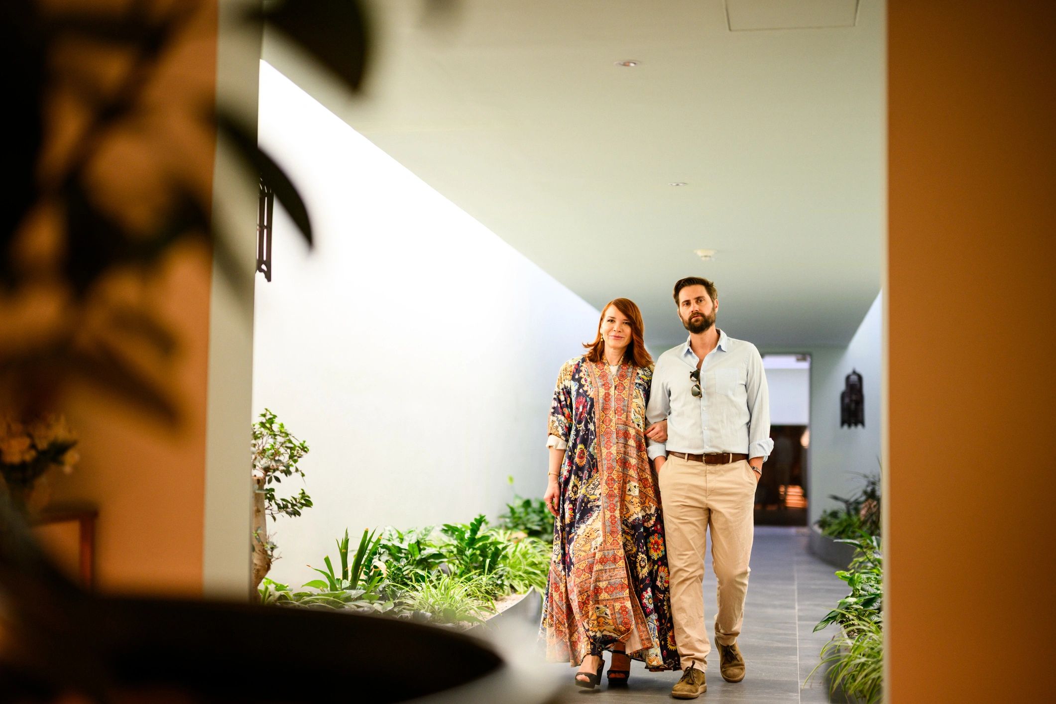 Couple walking through a modern luxury hotel while traveling